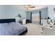 Comfortable bedroom features blue walls, carpet floors and a large window with natural light at 6040 Boulder Bluff Dr, Cumming, GA 30040