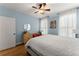 Light blue bedroom featuring hardwood floors, ceiling fan, and lots of natural light at 6040 Boulder Bluff Dr, Cumming, GA 30040