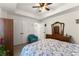 Comfortable bedroom with modern ceiling fan, hardwood furniture, and large bay windows at 6040 Boulder Bluff Dr, Cumming, GA 30040