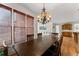 Bright dining room with large window, hardwood floors, and stylish chandelier at 6040 Boulder Bluff Dr, Cumming, GA 30040