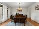 Elegant dining room with hardwood floors, wainscoting, and a stylish chandelier over a wooden table at 6040 Boulder Bluff Dr, Cumming, GA 30040