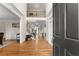 Inviting foyer with hardwood floors, elegant staircase, and natural light streaming through the doorway at 6040 Boulder Bluff Dr, Cumming, GA 30040