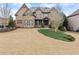 Attractive two-story home with a well-maintained lawn, brick and stone facade, and inviting curb appeal at 6040 Boulder Bluff Dr, Cumming, GA 30040