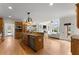 Kitchen with island, granite countertops, custom cabinets, and stainless steel appliances at 6040 Boulder Bluff Dr, Cumming, GA 30040