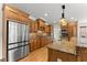 A spacious kitchen features wood cabinets, stainless steel appliances, and granite countertops at 6040 Boulder Bluff Dr, Cumming, GA 30040