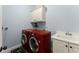 Laundry room featuring blue walls, washer, dryer, sink and cabinet at 6040 Boulder Bluff Dr, Cumming, GA 30040