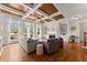 Bright living room with coffered ceilings, built-in bookshelves, and a fireplace at 6040 Boulder Bluff Dr, Cumming, GA 30040