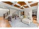 Living room featuring wood floors, stairway, and coffered ceilings at 6040 Boulder Bluff Dr, Cumming, GA 30040