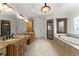 Spacious main bathroom featuring a separate shower and tub with granite countertops at 6040 Boulder Bluff Dr, Cumming, GA 30040
