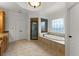 Spacious main bathroom featuring a separate shower, tub, and double doors at 6040 Boulder Bluff Dr, Cumming, GA 30040