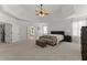 Spacious main bedroom with carpet flooring, tray ceilings and sitting area at 6040 Boulder Bluff Dr, Cumming, GA 30040