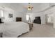 Spacious main bedroom with carpet flooring, tray ceilings and sitting area at 6040 Boulder Bluff Dr, Cumming, GA 30040