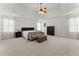 Spacious main bedroom with tray ceiling, plush carpeting, and lots of natural light at 6040 Boulder Bluff Dr, Cumming, GA 30040