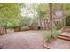 Expansive backyard with gravel, lush greenery, and a brick pathway leading to the main building at 746 United Se Ave, Atlanta, GA 30312
