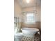Bathroom with a vintage tub, window, and classic black and white tile floor at 746 United Se Ave, Atlanta, GA 30312
