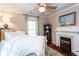 Bedroom with ceiling fan, fireplace, white iron bed frame, and natural light at 746 United Se Ave, Atlanta, GA 30312