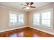 Bright bedroom featuring three windows, ceiling fan, and hardwood floors at 746 United Se Ave, Atlanta, GA 30312