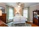 Bedroom with white iron bed frame, ceiling fan, and natural light at 746 United Se Ave, Atlanta, GA 30312