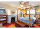 Bedroom view with a fireplace, four-poster bed, and decorative rug at 746 United Se Ave, Atlanta, GA 30312