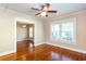 Bright bedroom featuring three windows, ceiling fan, and hardwood floors at 746 United Se Ave, Atlanta, GA 30312