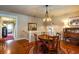Open dining room with hardwood floors, a round table, and a view of the staircase at 746 United Se Ave, Atlanta, GA 30312