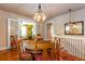 Bright dining room with hardwood floors, vintage chandelier, and direct access to additional rooms at 746 United Se Ave, Atlanta, GA 30312