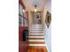 Warm and inviting entryway featuring hardwood floors, staircase with white risers, and stylish decor at 746 United Se Ave, Atlanta, GA 30312