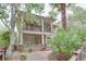Charming two-story home featuring a cozy front porch and second story balcony surrounded by lush landscaping at 746 United Se Ave, Atlanta, GA 30312
