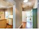 Hallway leading to a bathroom and kitchen with hardwood floors and classic design at 746 United Se Ave, Atlanta, GA 30312
