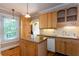Bright kitchen with light wood cabinets, island, white appliances, subway tile backsplash, and hardwood floors at 746 United Se Ave, Atlanta, GA 30312
