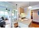 Bright kitchen featuring an island, stainless sink, light wood cabinets, and a sunny breakfast nook with built-in seating at 746 United Se Ave, Atlanta, GA 30312