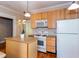 Kitchen with island, gas range, microwave, white refrigerator and light wooden cabinetry at 746 United Se Ave, Atlanta, GA 30312