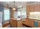 Charming kitchen with an island, stainless sink, light wood cabinets, and a sunny breakfast nook with built-in seating at 746 United Se Ave, Atlanta, GA 30312
