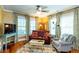 Cozy living room featuring hardwood floors, large windows, and stylish decor, creating a warm and inviting atmosphere at 746 United Se Ave, Atlanta, GA 30312