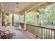 Relaxing second-story porch with chairs, a table, and lush green surrounding landscaping at 746 United Se Ave, Atlanta, GA 30312