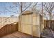 Exterior view of a shed, featuring a wooden platform and garden bed, surrounded by a wooden fence at 746 United Se Ave, Atlanta, GA 30312