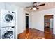 View from sunroom into kitchen featuring stacked washer and dryer, hardwood floors, and white shiplap walls at 746 United Se Ave, Atlanta, GA 30312