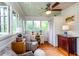 Bright, airy sunroom with a ceiling fan, large windows, hardwood floor, and comfortable seating and a desk at 746 United Se Ave, Atlanta, GA 30312