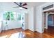 Bright sunroom features white shiplap walls, hardwood floors, windows, and a stacked washer and dryer at 746 United Se Ave, Atlanta, GA 30312