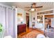 Bright sunroom with many windows, hardwood floors, ceiling fan, and access to kitchen at 746 United Se Ave, Atlanta, GA 30312