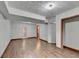 Spacious basement featuring wood-look flooring, textured ceilings, and access to storage space at 1922 Marshes Glenn Dr, Norcross, GA 30071