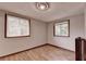 Bedroom features wood floor and two windows with natural light at 1922 Marshes Glenn Dr, Norcross, GA 30071