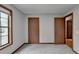 Bedroom with window and two doors at 1922 Marshes Glenn Dr, Norcross, GA 30071