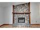 Stone fireplace with mantel and hearth at 1922 Marshes Glenn Dr, Norcross, GA 30071