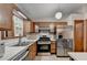 Kitchen with stainless steel appliances, light countertops, and oak cabinets at 1922 Marshes Glenn Dr, Norcross, GA 30071