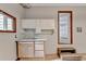 Kitchenette with white cabinets, sink, and a step-up at 1922 Marshes Glenn Dr, Norcross, GA 30071
