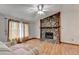 Comfortable living room with stone fireplace, wood-look floors and natural light from the window at 1922 Marshes Glenn Dr, Norcross, GA 30071