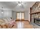 Cozy living room featuring a stone fireplace, wood-look flooring, and neutral wall paint at 1922 Marshes Glenn Dr, Norcross, GA 30071