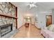 Open living and dining space features a stone fireplace and hardwood flooring at 1922 Marshes Glenn Dr, Norcross, GA 30071
