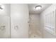 Bathroom featuring a shower, mirror, and natural light from the window at 3359 Mansfield Ln, Snellville, GA 30039